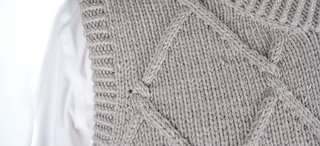 Vest with braid detail knitted from Grivette Design's knitting pattern no 009